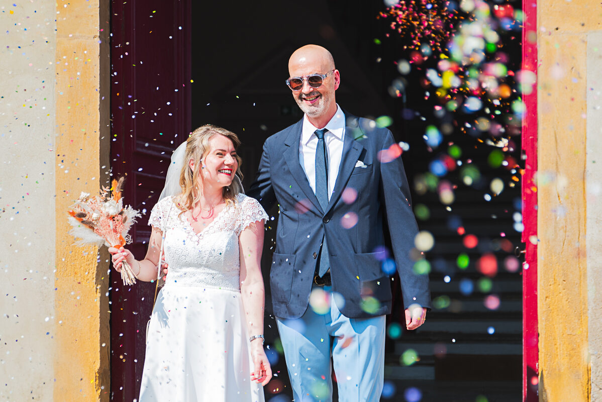La sortie des mariés - Photo de mariage à Nancy Les mariés sortent de la mairie sous les confétis
